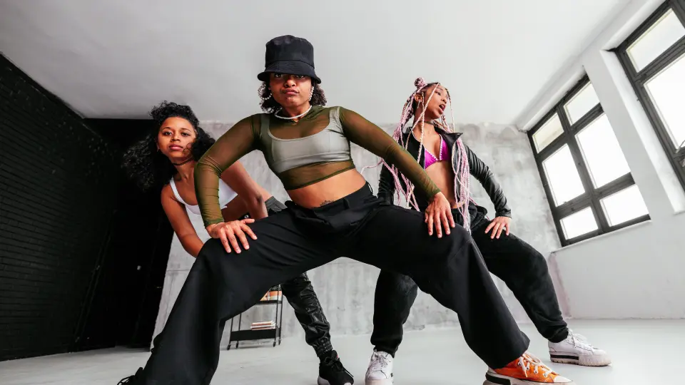 three female hip hop dancers do a dance routine.